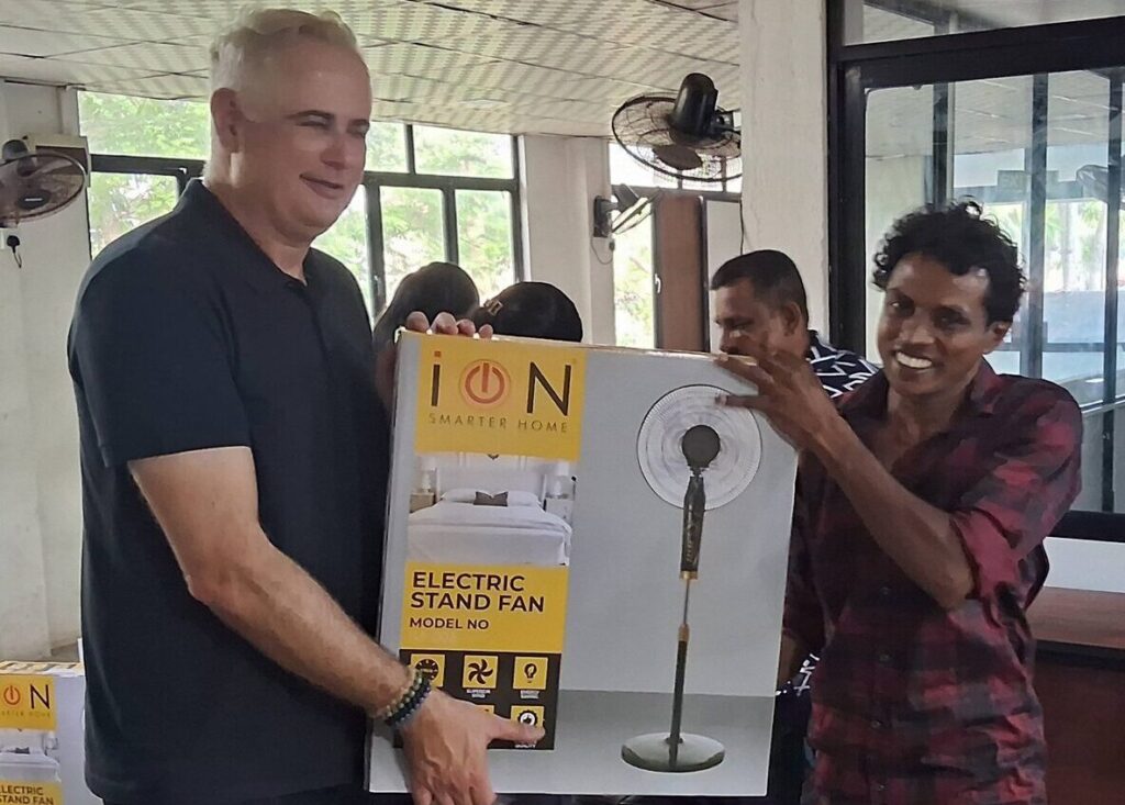 M. Koenraad Pringiers giving new years present to a Solar Impulse employee